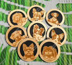 Set of wooden dog hanging air fresheners with engraved dog breeds on a green and white striped background.