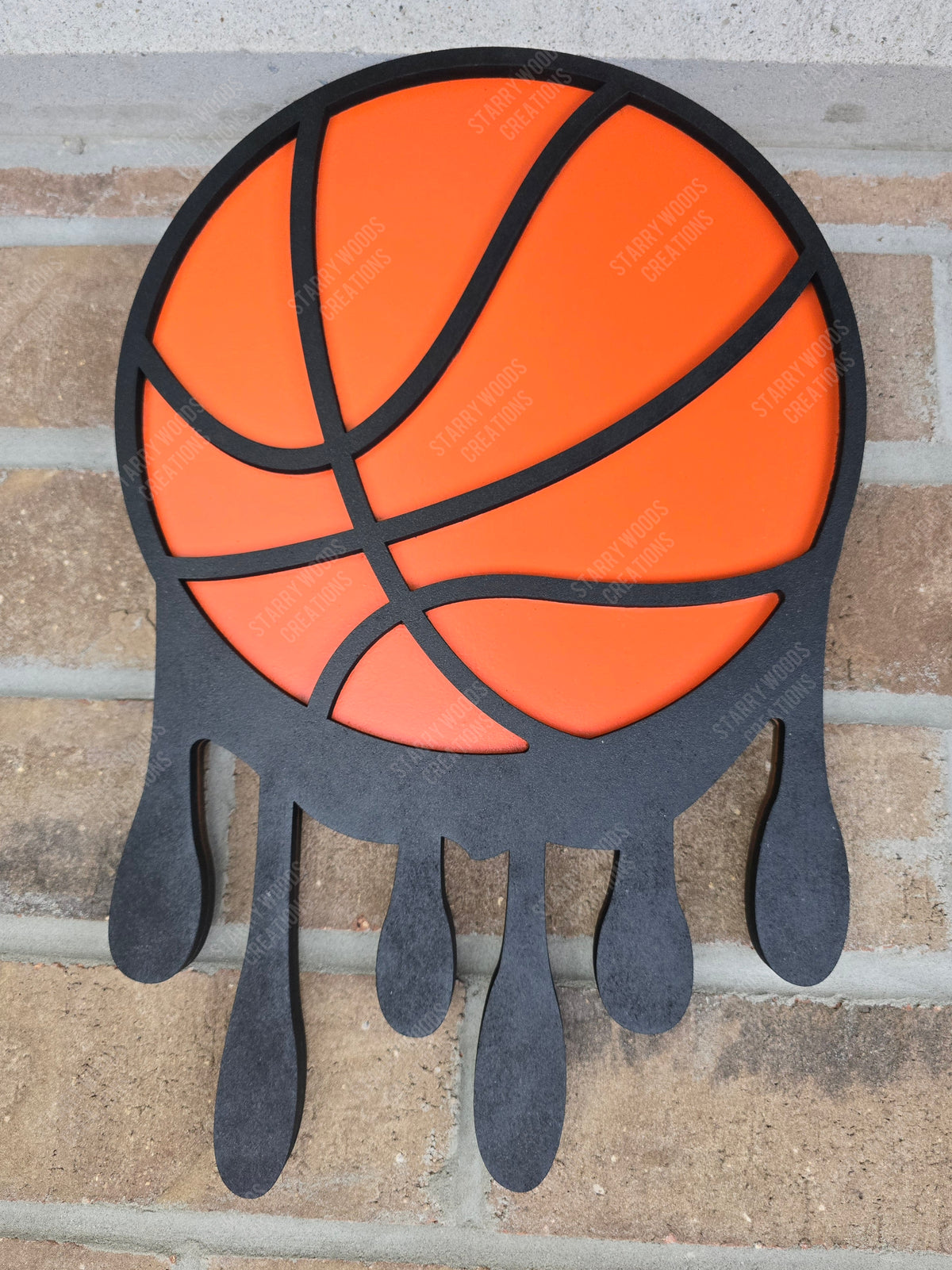Decorative wall art of a basketball with details that make it look like its melting