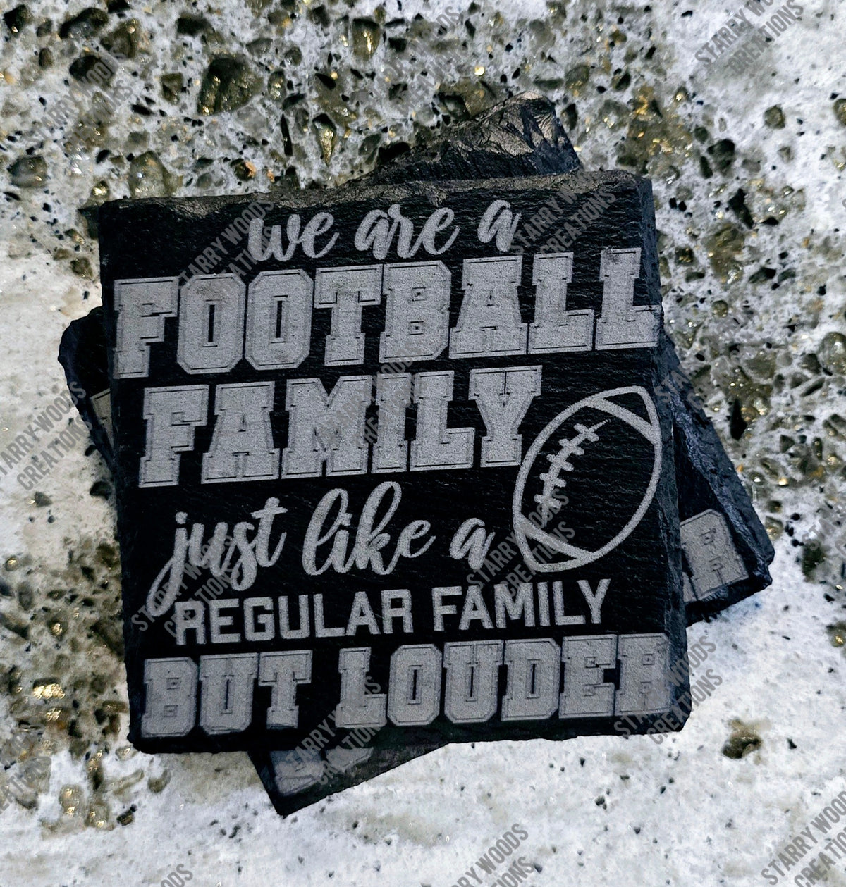 Stack of black slate coasters engraved with a humorous quote about being a football family