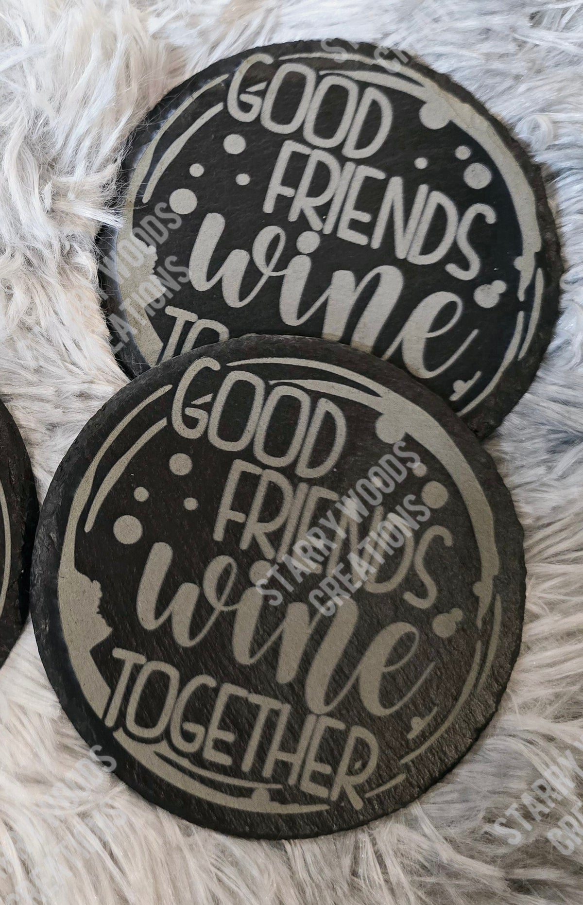 Two round slate coasters engraved with "good friends wine together" 