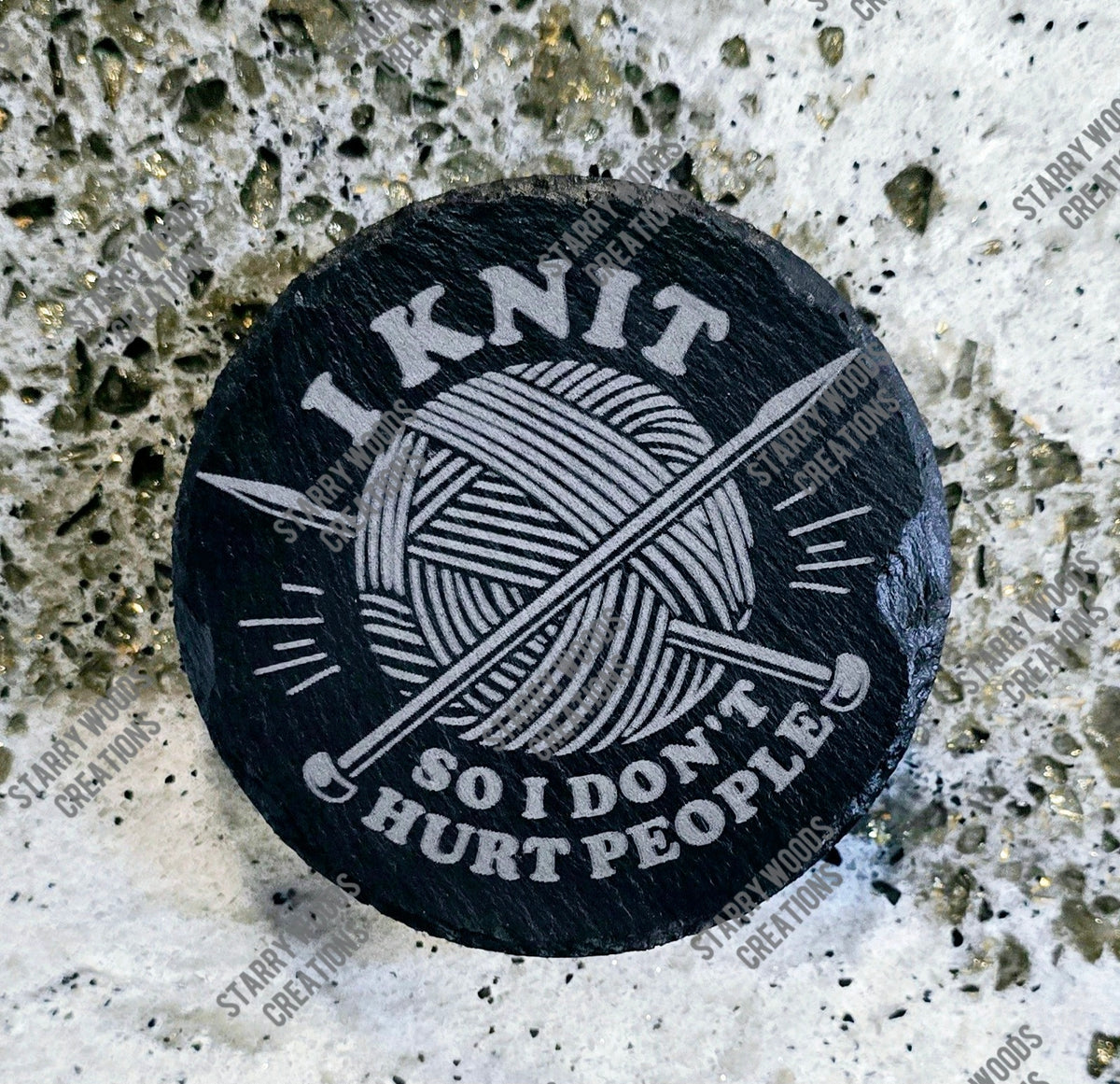Black round slate coaster with 'I Knit So I Don't Hurt People' text and yarn ball design, handmade in Ontario.