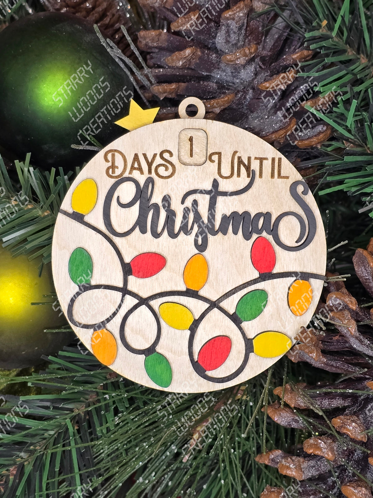 A wooden Christmas countdown ornament with colorful numbered light designs and the text 'days until Christmas' in a circular arrangement, placed against a festive background. Handmade in Quinte West and customizable.