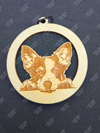 Wooden hanging air freshener with a laser-cut collie dog design on a blue background