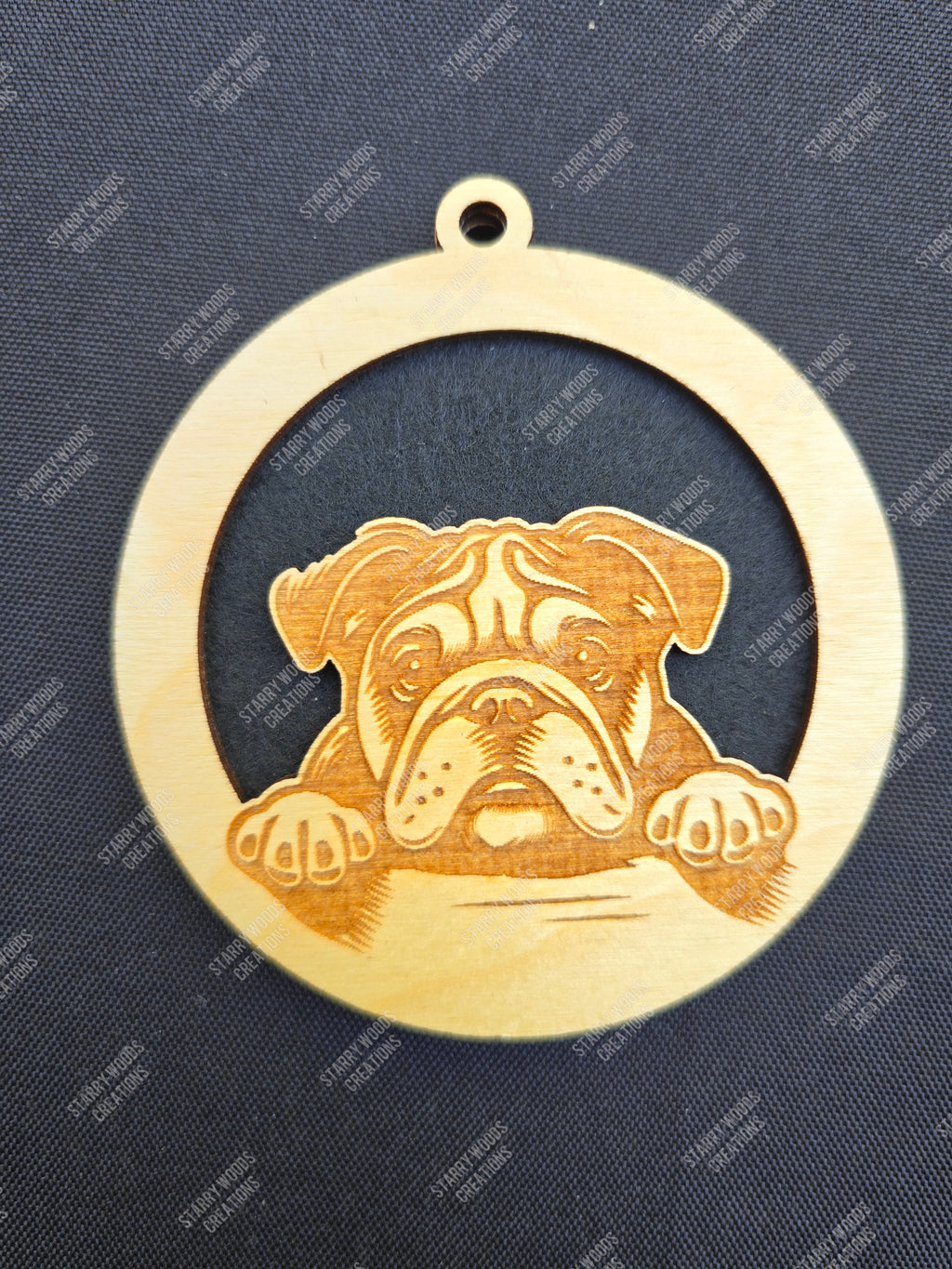 Wooden hanging air freshener with a bulldog design on a dark blue background