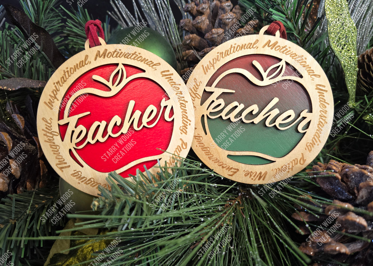 Two 'Teacher' ornaments on a Christmas tree with pine cones.