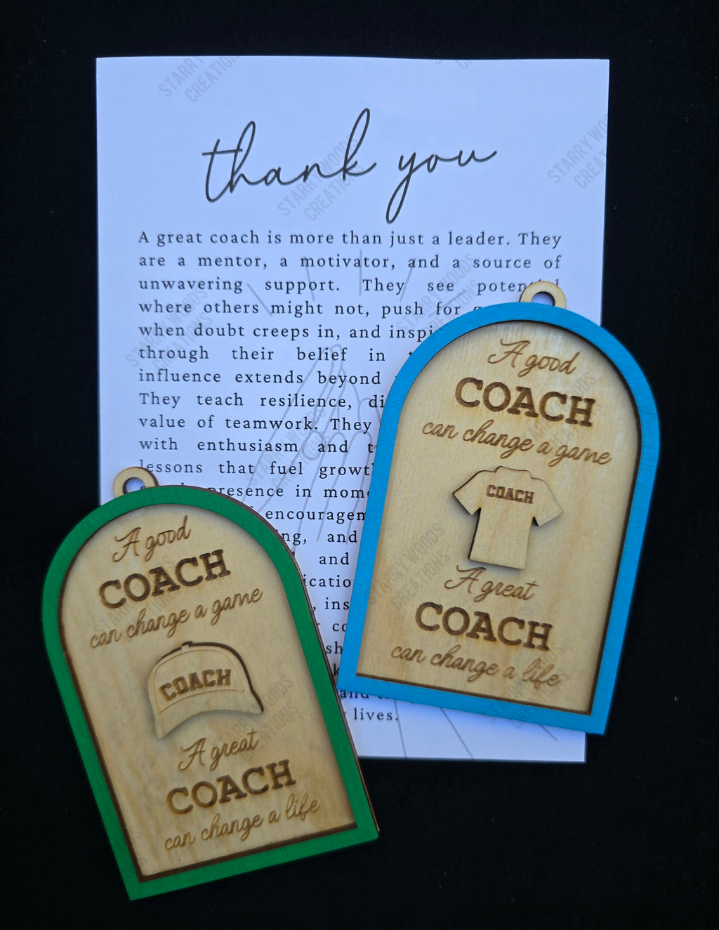 Two wooden ornaments with thank you coach engraved text and 3D apparel detail on a black background