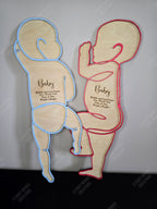 Two wooden baby silhouettes. Coloured line drawing outline with engraving space for baby's birth stats. To be made 1:1 to match baby's height at birth, perfect as a keepsake or gift.
