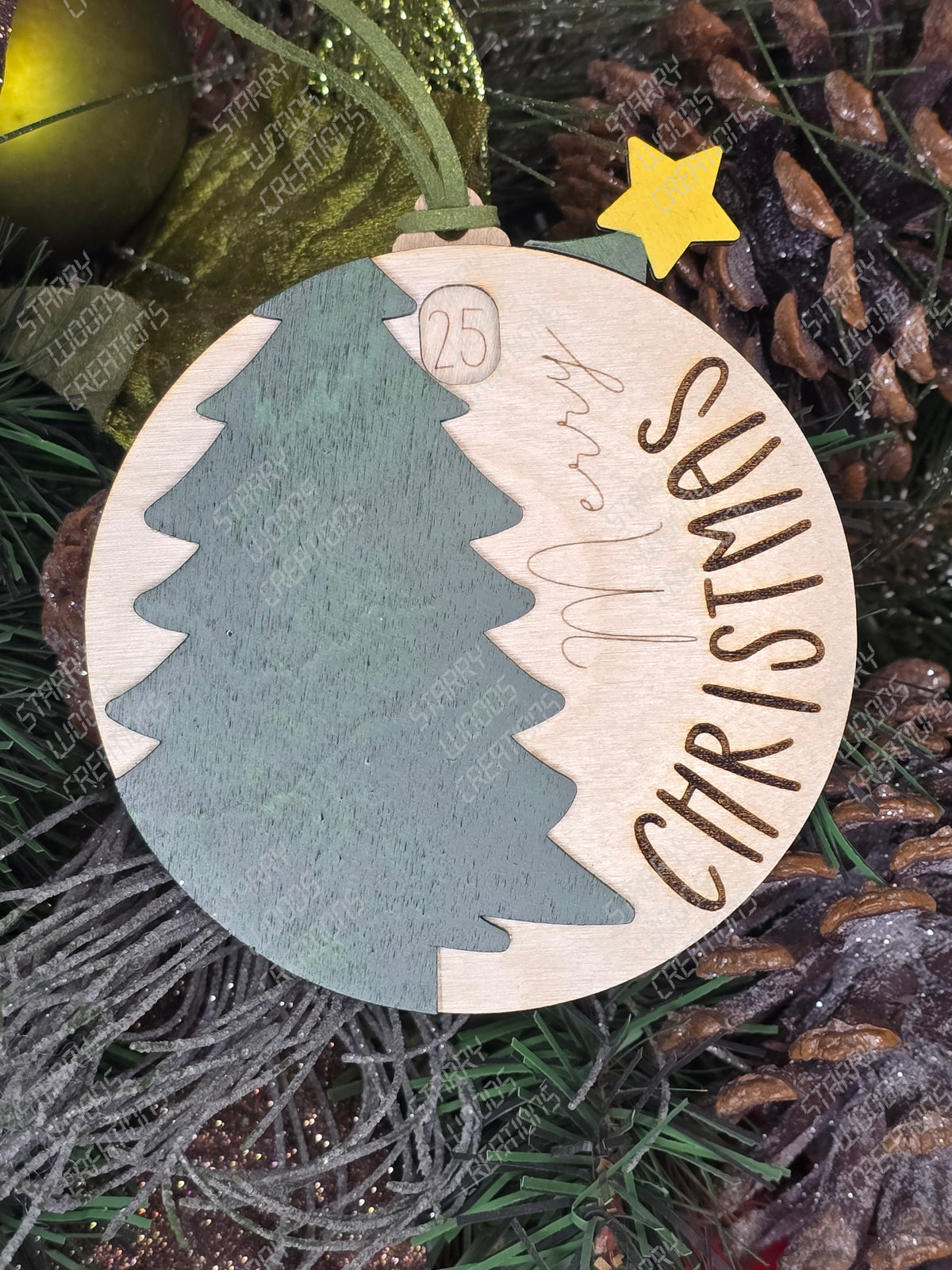 A Christmas countdown ornament with a tree and the word 'CHRISTMAS' written across, in green and white colors, with a yellow star on top. Handmade in Quinte West.
